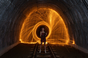 Woman spinning wire wool in tunnel