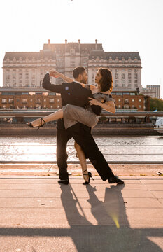 Male and female Tango dancers doing practice on pier during summer