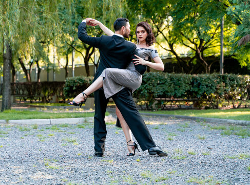 Male and female Tango dancers doing rehearsal in public park