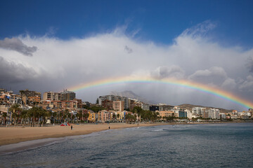 Rainbow over the old town of Villajoyosa with colorful houses, mountains and the sea, Spain