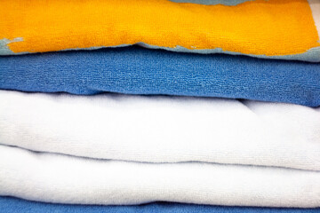 A stack of velvet towels. Image on the theme of knitwear, fabrics.