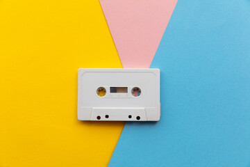 vintage white cassette tape on a colourful background