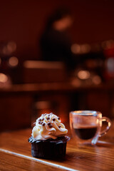 Delicious dessert and coffee on the wooden table in cafe.