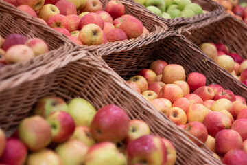Boxes of juicy apples in the supermarket. Photo on the theme of fruit.