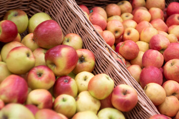 Naklejka na ściany i meble Boxes of juicy apples in the supermarket. Photo on the theme of fruit.