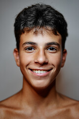 Close-up studio portrait of handsome teenage boy.