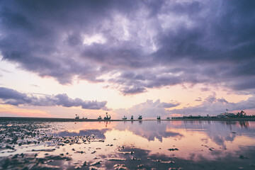 Beautiful tropical sunset. Seascape with purple sky and longtail boats. Samui Island, Thailnd.
