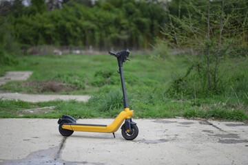 Yellow electric electric scooter on black wheels