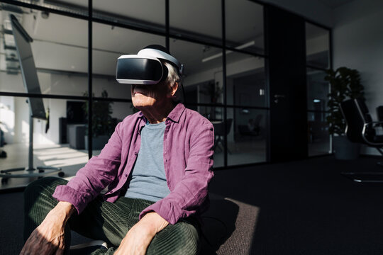 Entrepreneur using virtual reality headset while sitting in office