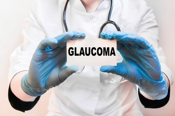 the doctor in gloves holds a card with the text GLAUCOMA . white background. the medicine
