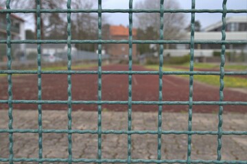 metal grid fence in front of a playing field