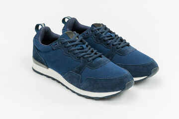 NEW BLUE, CASUAL, FASHIONABLE AND STYLISH SNEAKERS ON WHITE BACKGROUND. SPORTSWEAR, SHOPPING AND GIFTS CONCEPT.