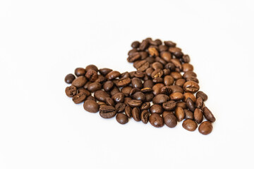 heart shaped coffee beans. close-up photo of coffee beans on a white background. love of coffee