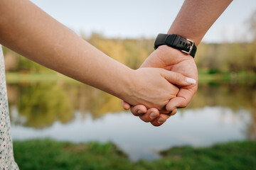 young people in love hold hands