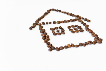 coffee beans on a white background in the shape of a house. homemade coffee.