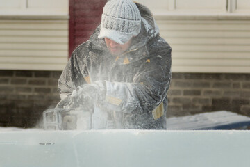 Facial portrait of a sculptor with a chainsaw at work