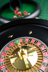 Casino theme.  Roulette wheel on green table.
