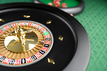 Casino theme.  Roulette wheel on green table.