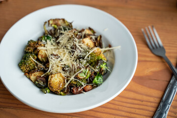 Roasted brussels sprouts topped with vegan cheese. Organic brussel sprouts recipe. 