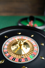 Casino theme.  Roulette wheel on green table.
