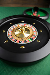Casino theme.  Roulette wheel on green table.