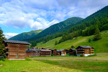 Switzerland, Valais, Ulrichen, Traditional wooden houses in summer mountain scenery
