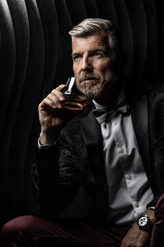 Portrait of a gentleman holding a glass of alcohol