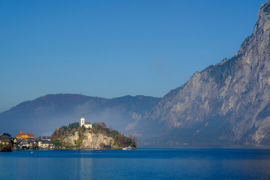 Austria, Upper Austria, Traunkirchen, Johannesbergkapelle with Traunstein peak towering over Traunsee lake