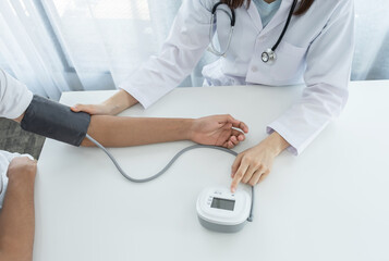 The doctor woman hand use the pulse meter to measure the pressure of the patient, medical checkup concept