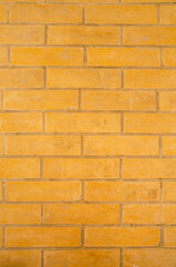 Texture background of yellow brick wall close up