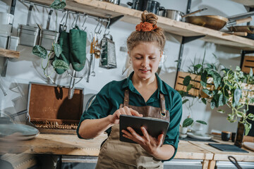 Young chef using digital tablet while standing in kitchen