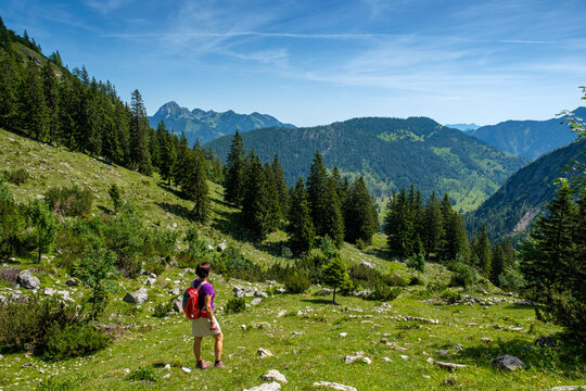 Mature hiker looking view while standing on Schellenberg-Alm mountain at Bavaria, Germany