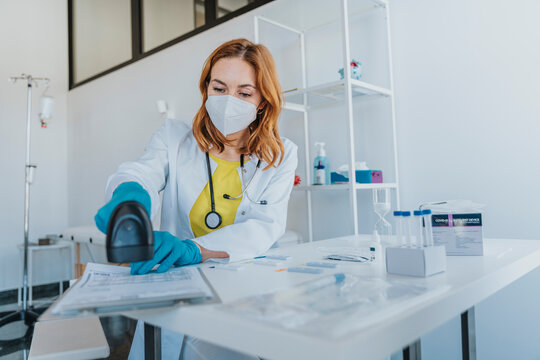Expertise using medical scanner over document while working at examination room