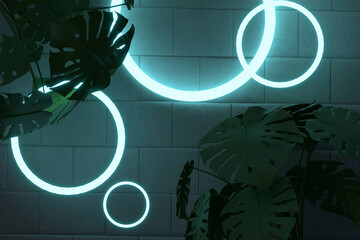 Silhouette plants against illuminated circle shape lights on brick wall