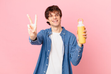 young man with a smoothy smiling and looking friendly, showing number two