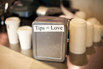Metallic tips box at cafe