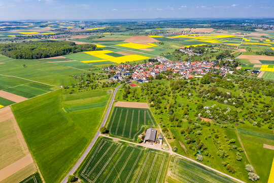 Germany, Hesse, Munzenberg, Helicopter view of countryside village and surrounding fields in summer