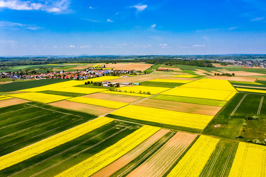Germany, Hesse, Munzenberg, Helicopter view of countryside village and surrounding fields in summer