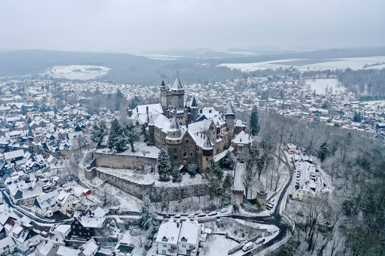 Germany, Hesse, Braunfels, Helicopter view of Braunfels Castle and surrounding town in winter