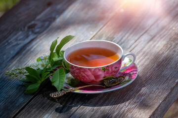 Morning cup of tea on the background of the spring garden.