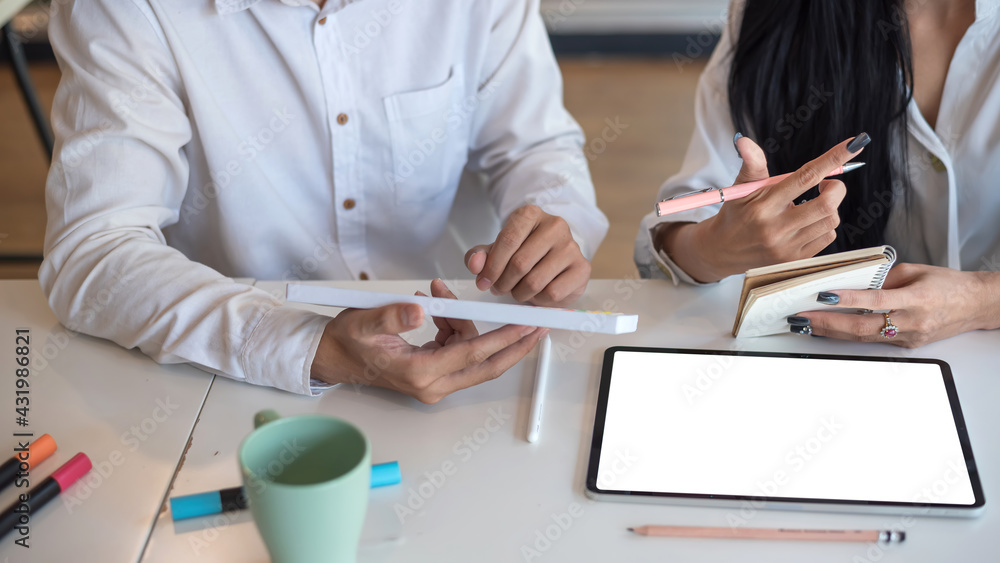 Poster close-up of the designers team brainstorming collaboration using a tablet blank white screen at the 