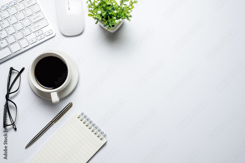 Poster top view of the desk with keyboard coffee notebook mouse placed on the desk white copy space flat pa