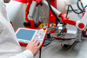 Male engineer operating control in factory