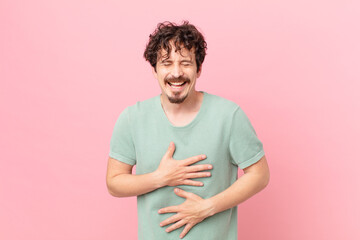 young handsome man laughing out loud at some hilarious joke