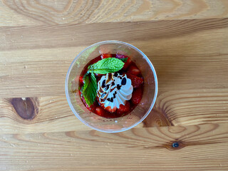 Delicious Italian Dessert Panna Cotta with Strawerry Sauce, Meringue and Fresh Mint Leaves.