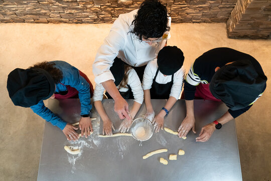 Top view of a family doing a cooking workshop