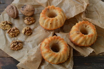 Traditional Wiener patisserie, mini bundt cakes Gugelhupf (Gugelhopf) with walnuts  on the baking paper