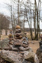 Fototapeta na wymiar zen stack of rocks stones in dark forest a symbol of harmony and balance