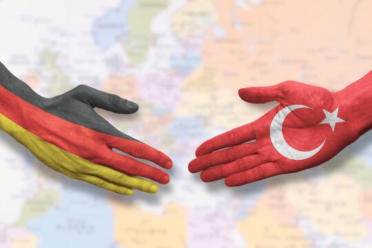 Turkey and Germany - Flag handshake symbolizing partnership and cooperation