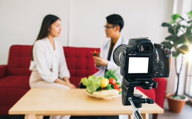 White screen camera recording of a nutritionist doctor is educating a young businessman about...